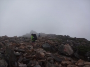 霧中の常念山頂を目指す健脚女性